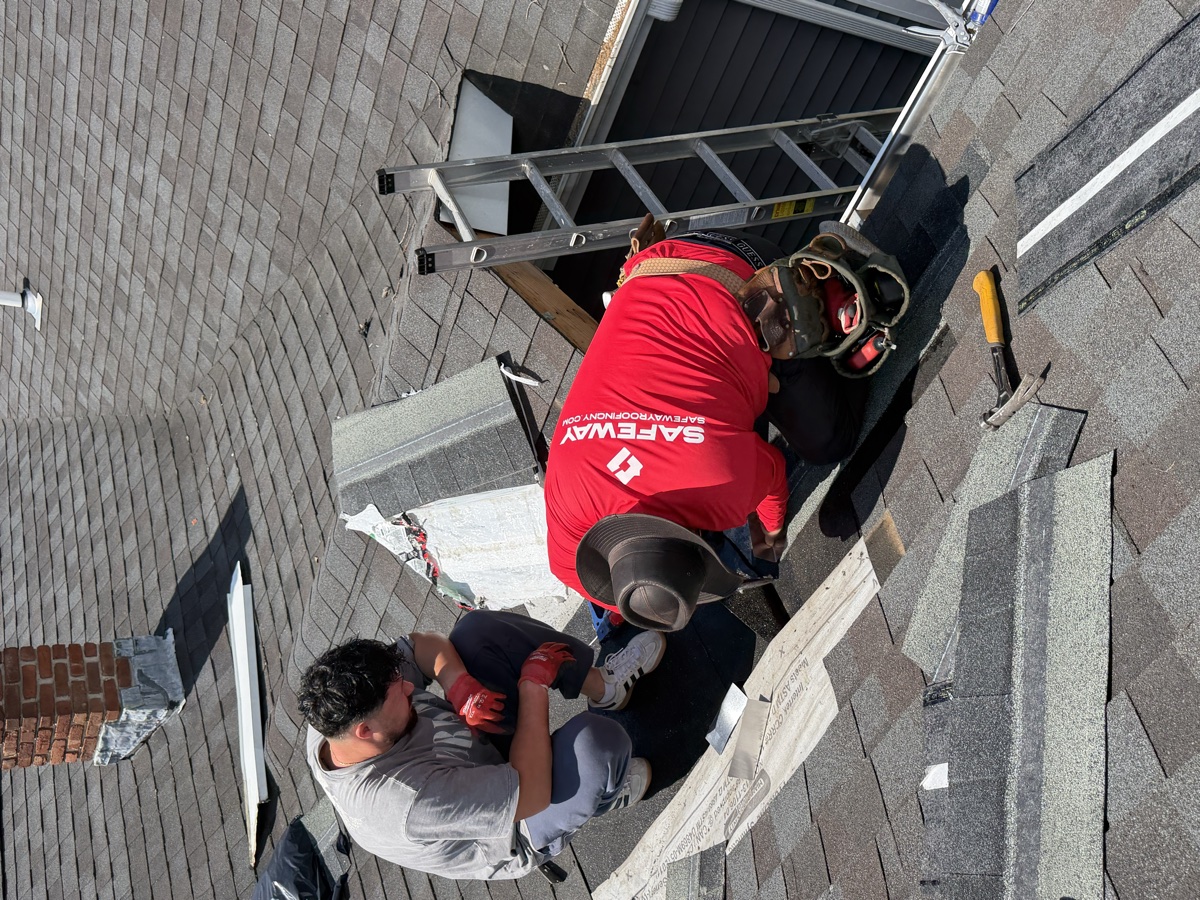 Safeway crew repairing shingles and flashing around a roof opening