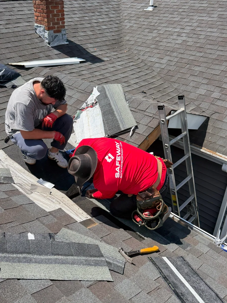 Safeway crew repairing shingles and flashing around a roof opening